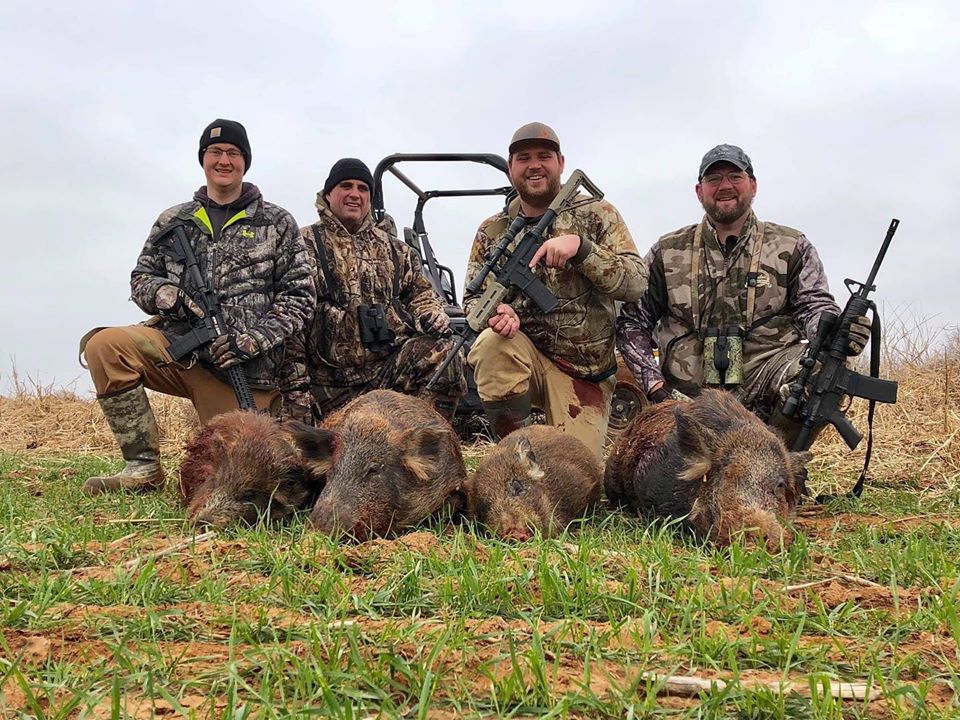 Oklahoma Hog Hunt, 1 group of hog hunters in Oklahoma during the day time with their hogs