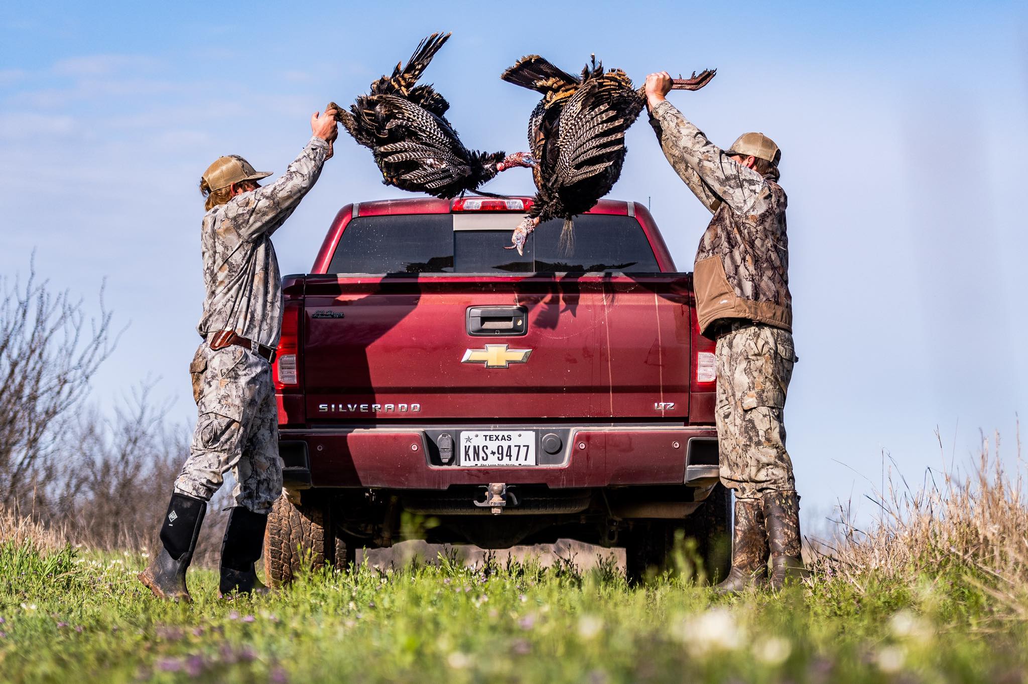 Two hunters shown with turkeys in Holliday, Texas after a successful hunt.