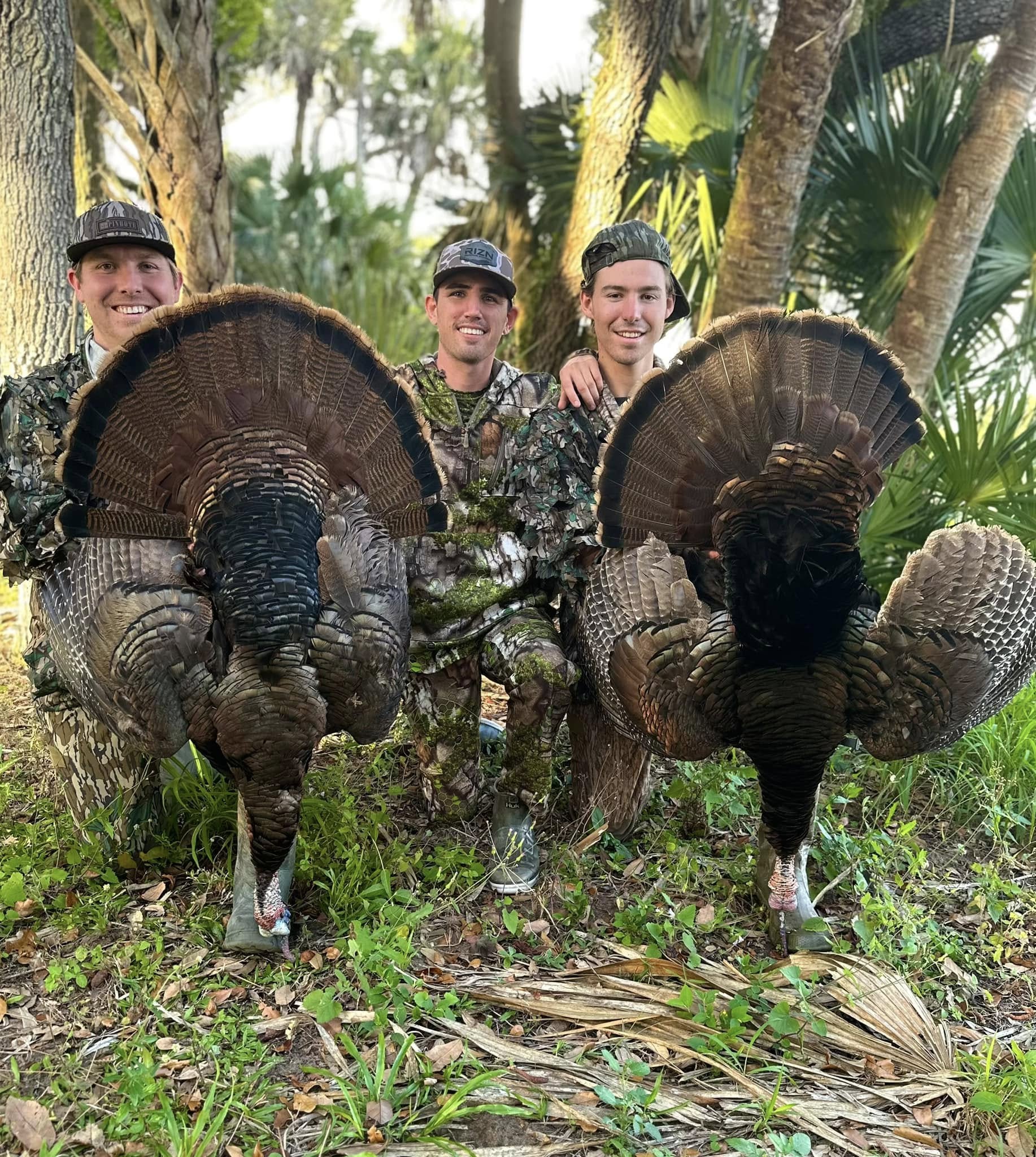 Osceola hunters in Florida with hunting guide, shown with two successful harvests. 