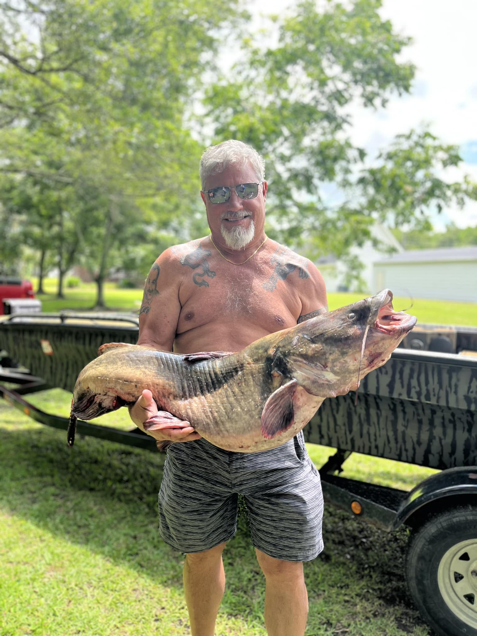 Angler shown with catfish he caught with the noodling technique.