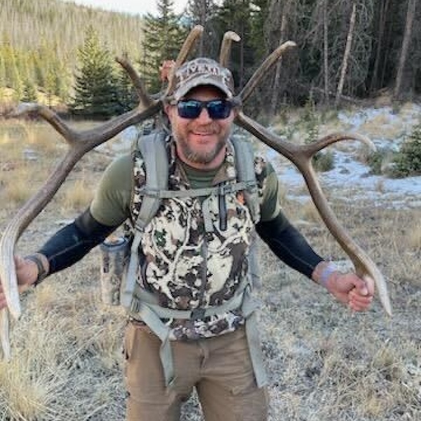 Bow hunter shown with turkey after a successful Spring turkey hunt in the Pacific Northwest, either Idaho or Washington state.
