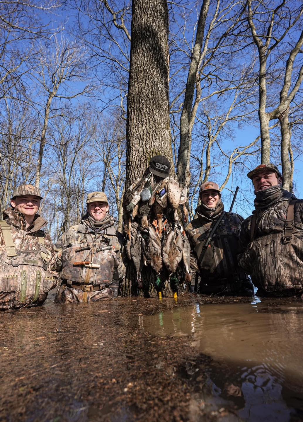 Osceola hunters in Florida with hunting guide, shown with two successful harvests. 